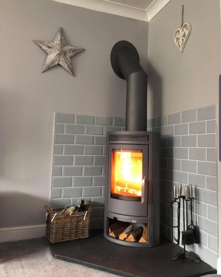 A corner stove on one of our bespoke five-sided pentagonal slate hearths