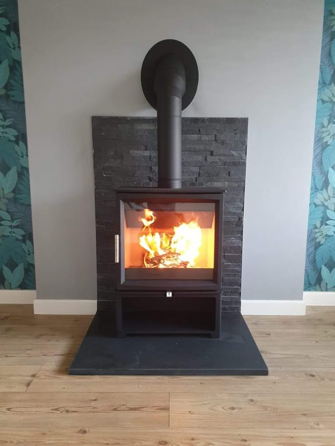 Contemporary square slate hearth now in use with its stove