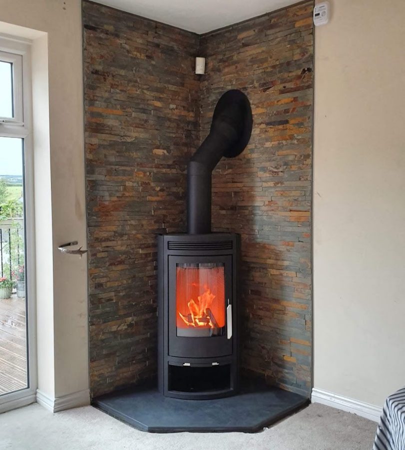One of our bespoke five-sided pentagonal slate hearths with a corner stove