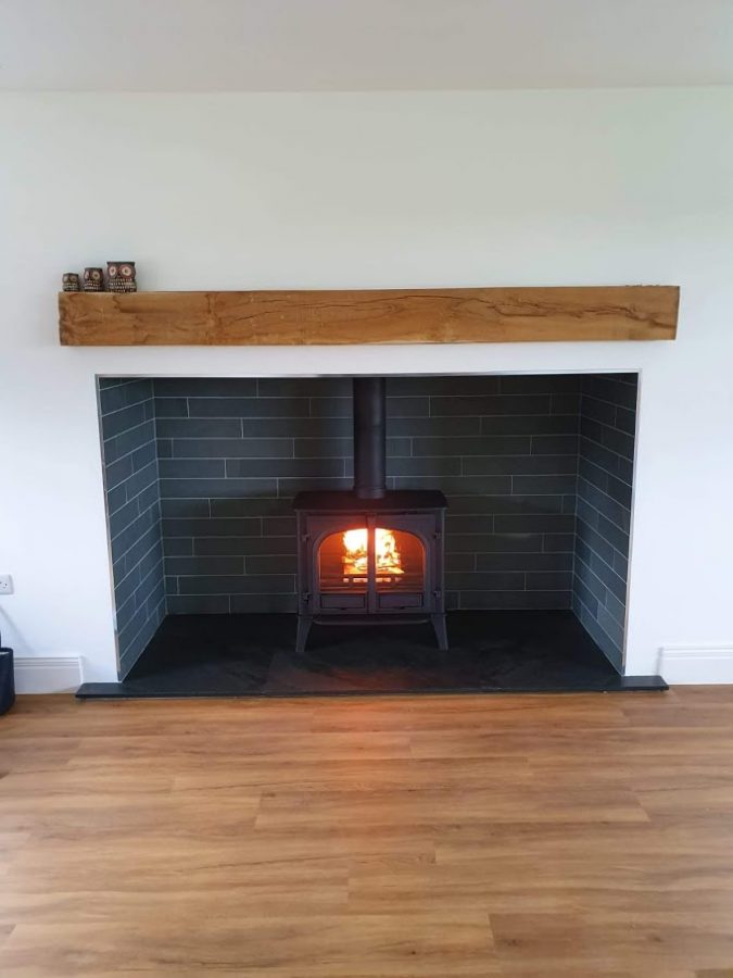 Perfect fitting made-to-measure slate hearth finishing off this stove and fireplace