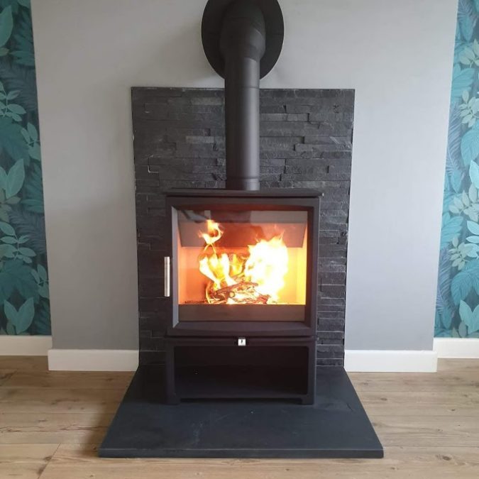 Contemporary square slate hearth now in use with its stove