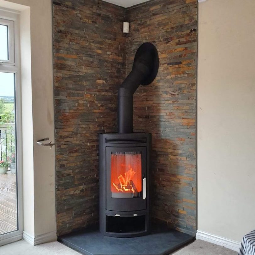 One of our bespoke five-sided pentagonal slate hearths with a corner stove