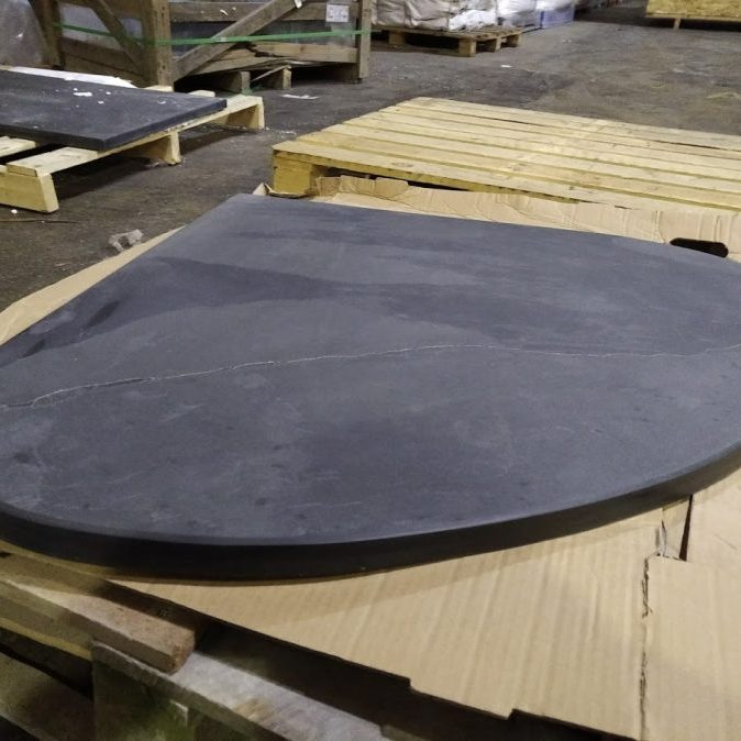 Wide teardrop shaped bespoke slate hearth for a corner