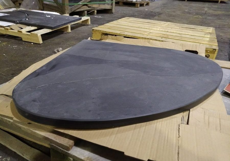 Wide teardrop shaped bespoke slate hearth for a corner